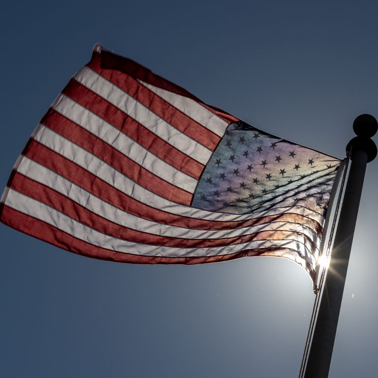 A U.S. flag against the blue sky
