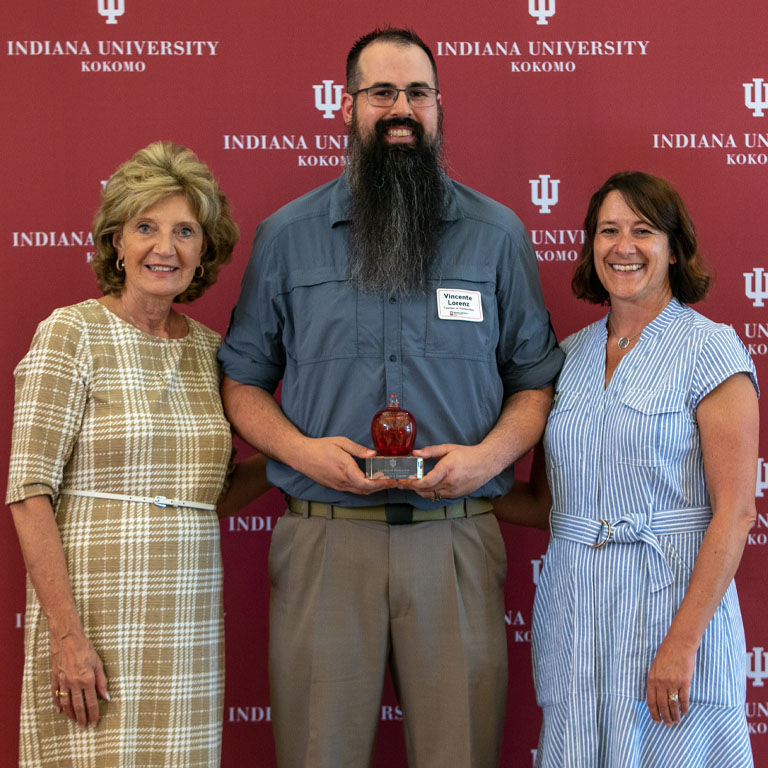 Chancellor Sciame-Giesecke and Dean Leah Nellis stand with this year's teacher of distinction, Vince Lorenz.