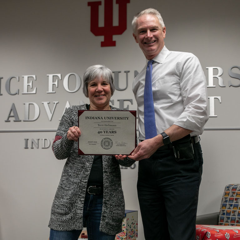 A woman and a man hold a certificate