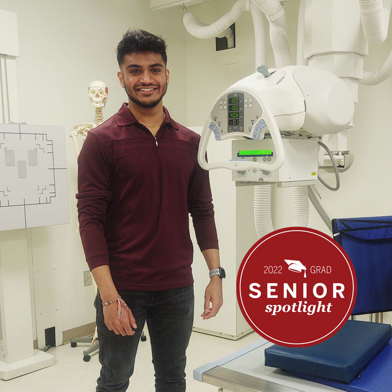 A man stands by a medical imaging machine