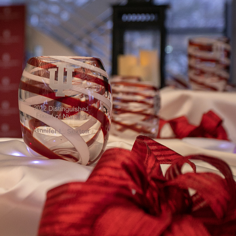 Image of a glass award with red and white swirls