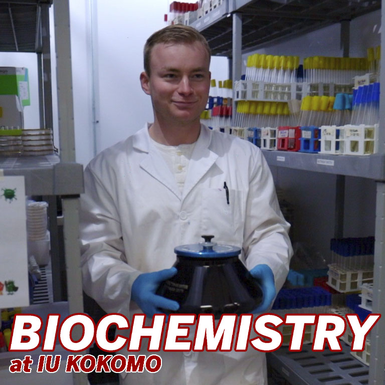 A man in a white coat in a lab