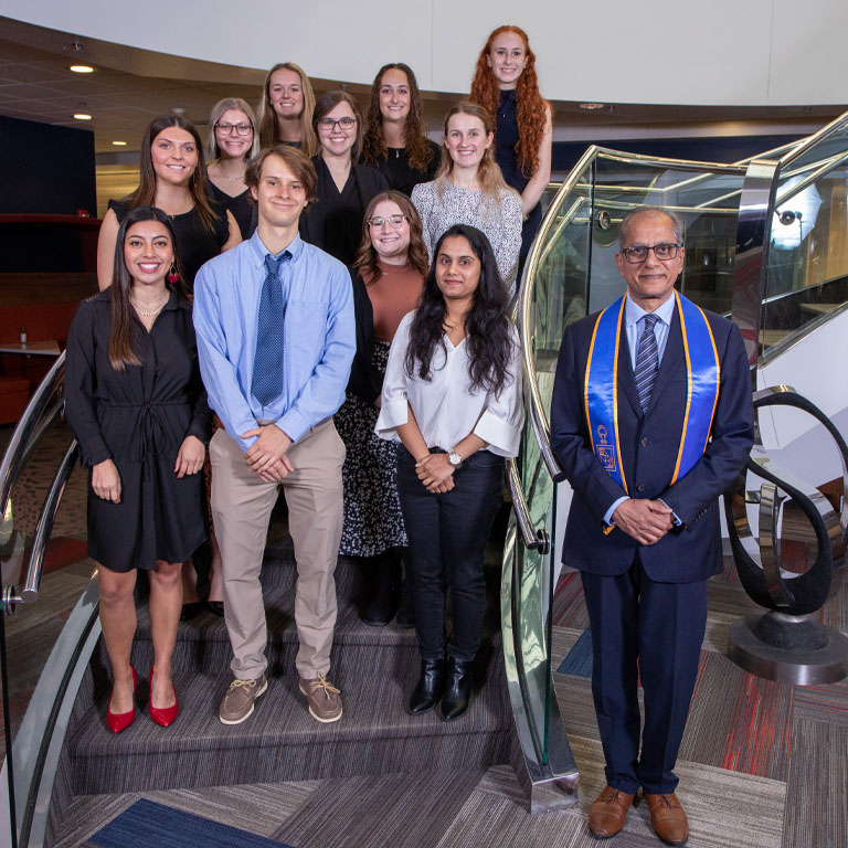 A group of people stand on a staircase