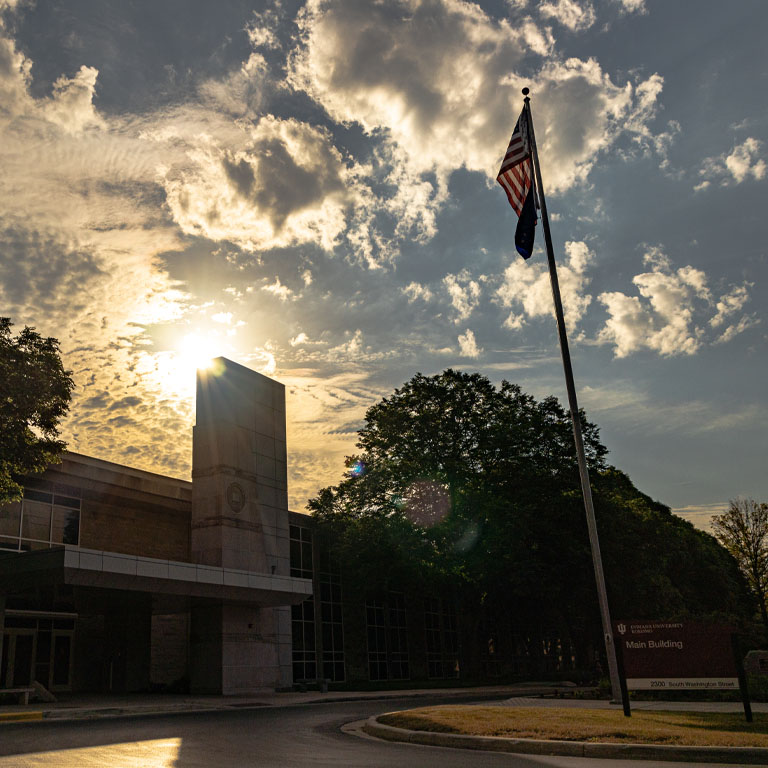 Main Building and flagpole at sunset