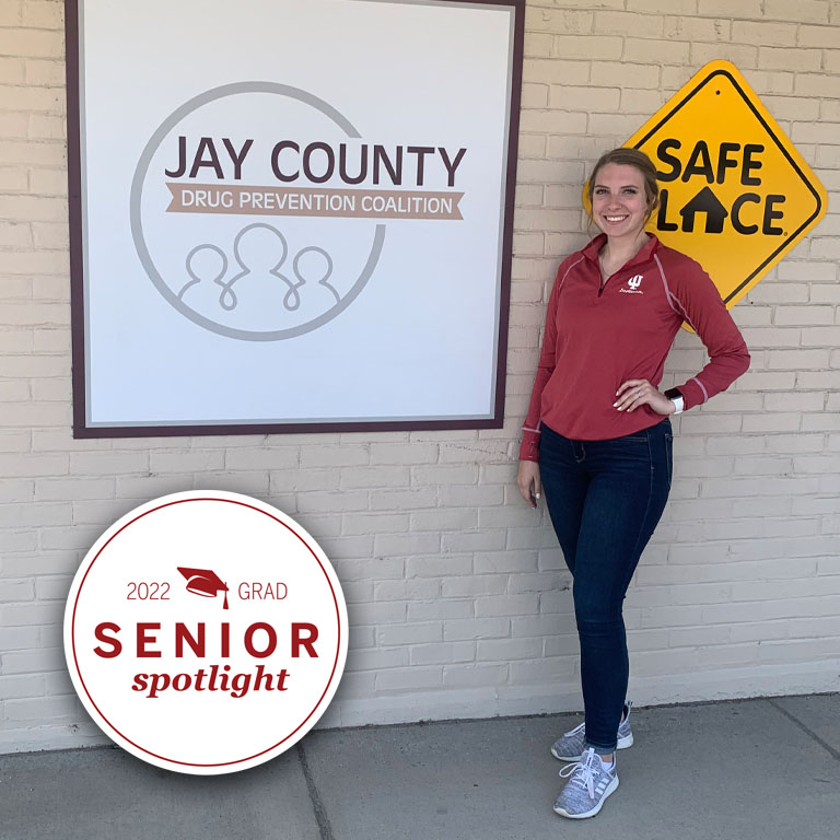 A woman stands by a Jay County Drug Prevention Coalition sign