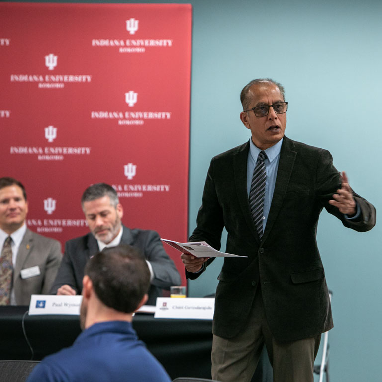 A man stands in front of a group of people