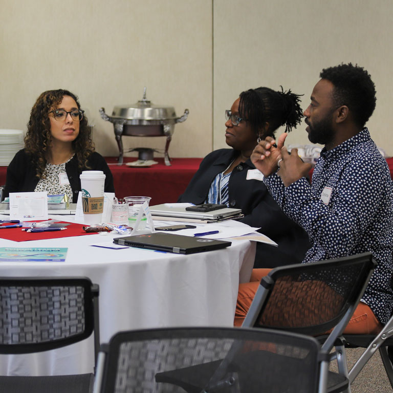 Two women and a man talk