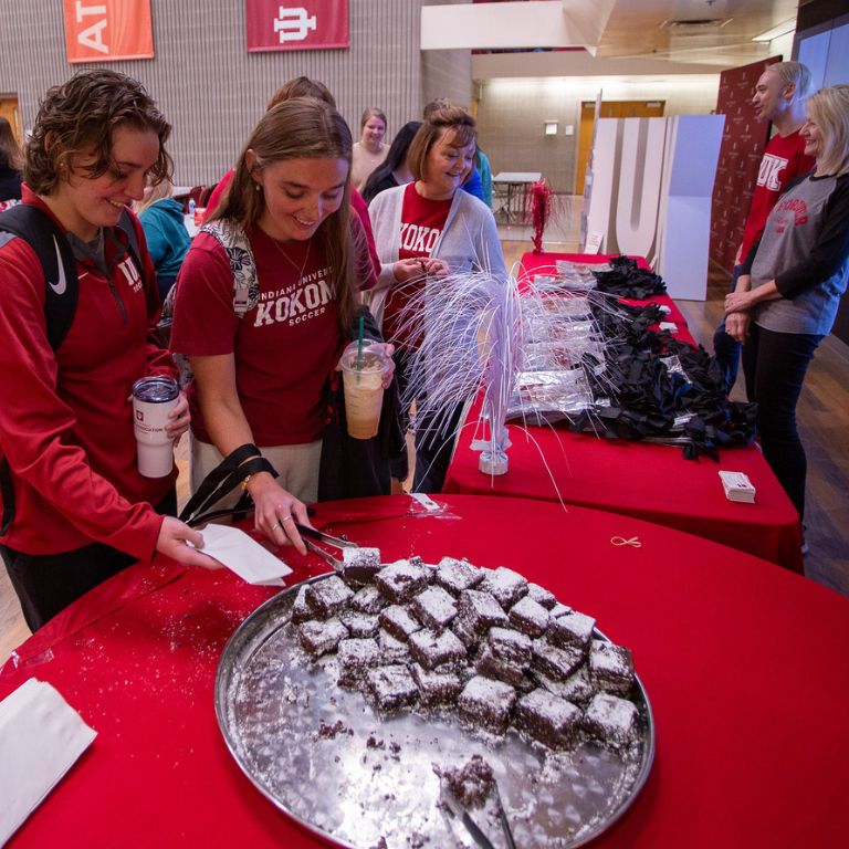 Students serve themselves a brownie