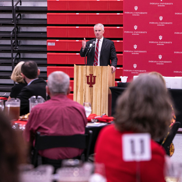 A man speaks at a podium