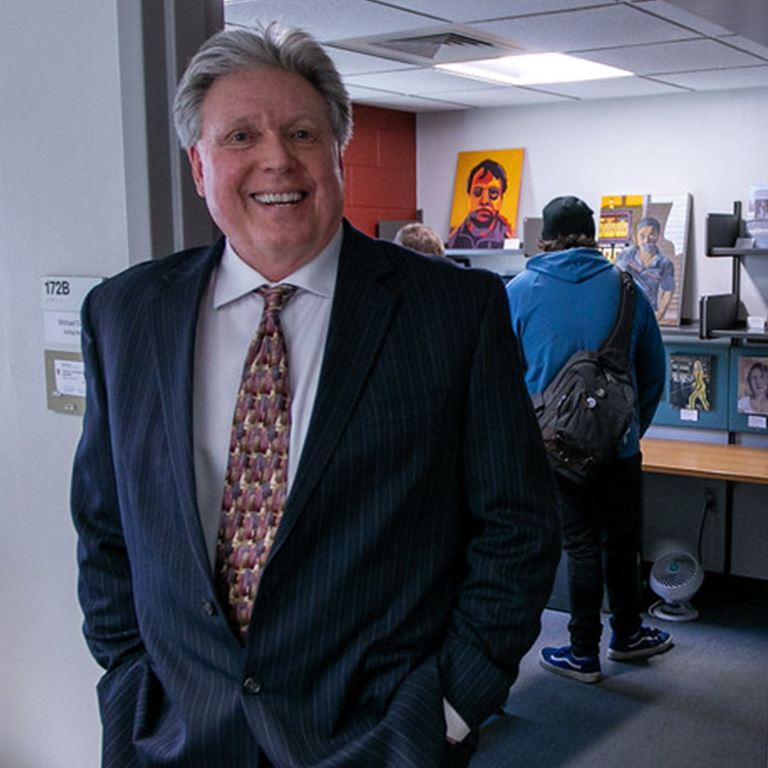 A man stands in an office doorway