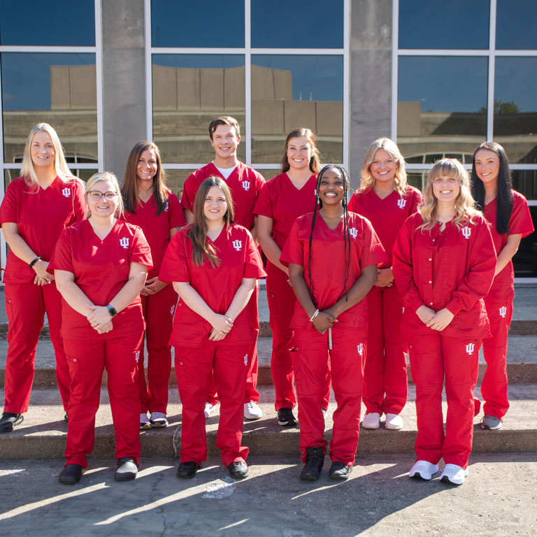A group of people wearing red scrubs