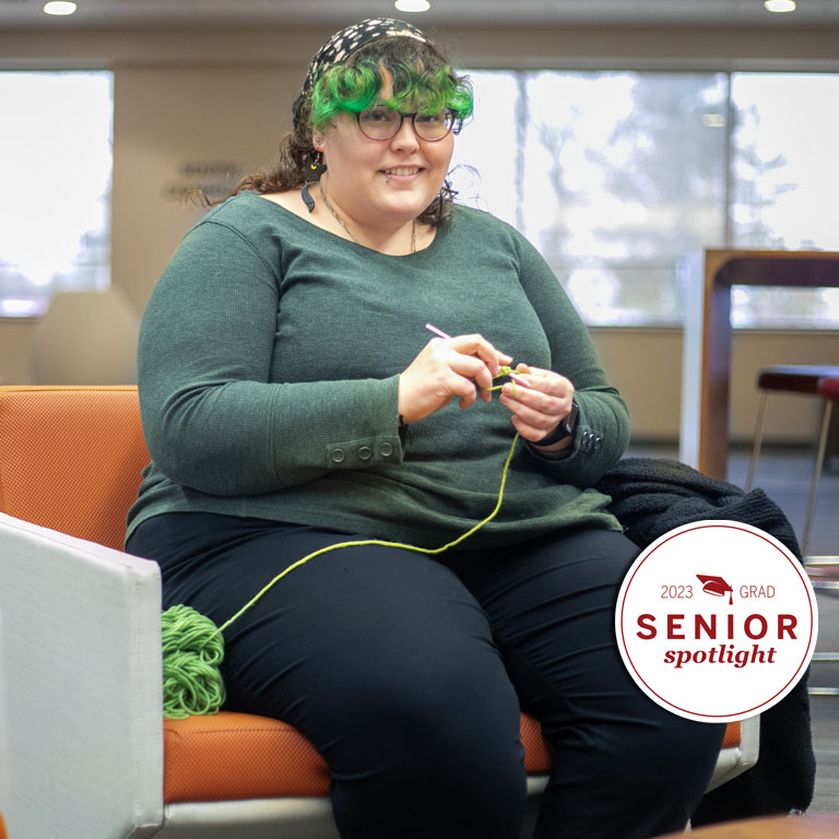A student crochets in the library