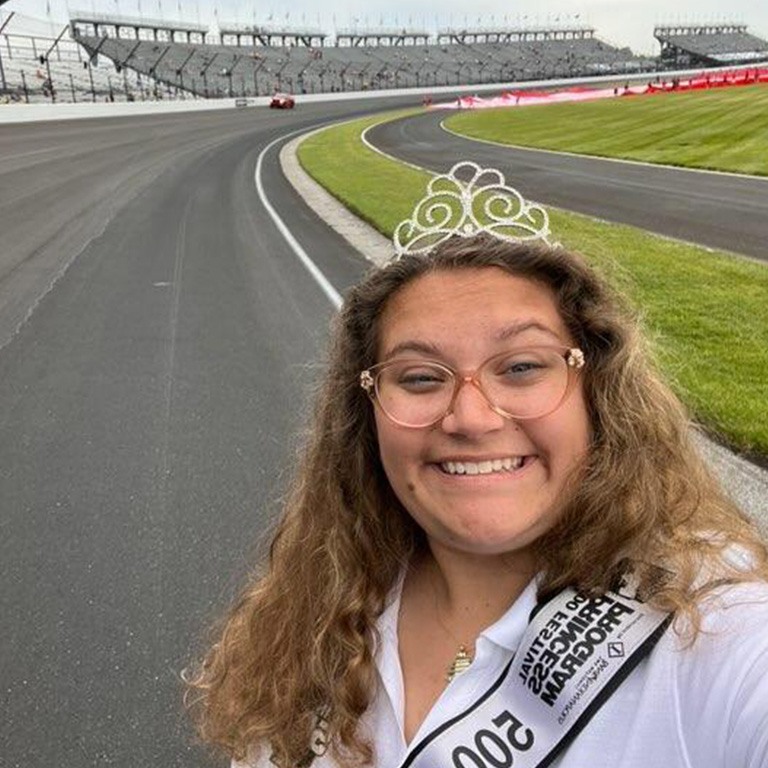 A woman wearing a tiara on a race track