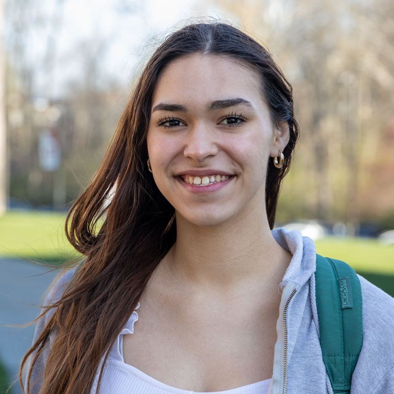 A woman smiles for a portrait