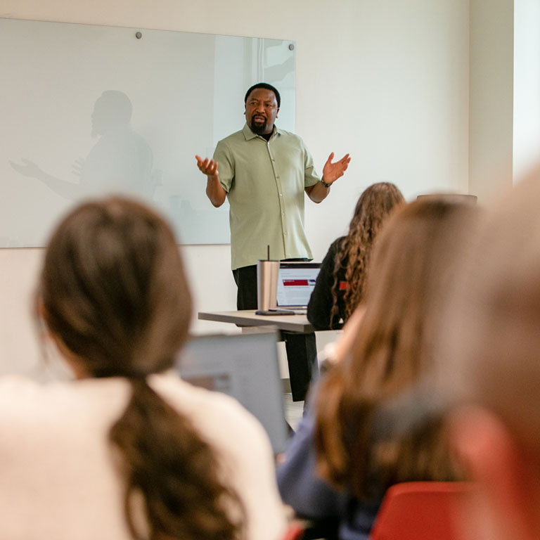 A man stands at the front of a classroom