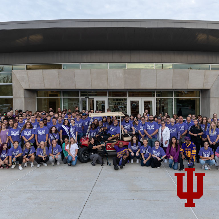 Group photo of people wearing purple T-shirts