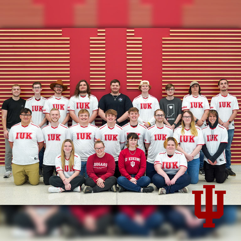 A group of people pose in three rows