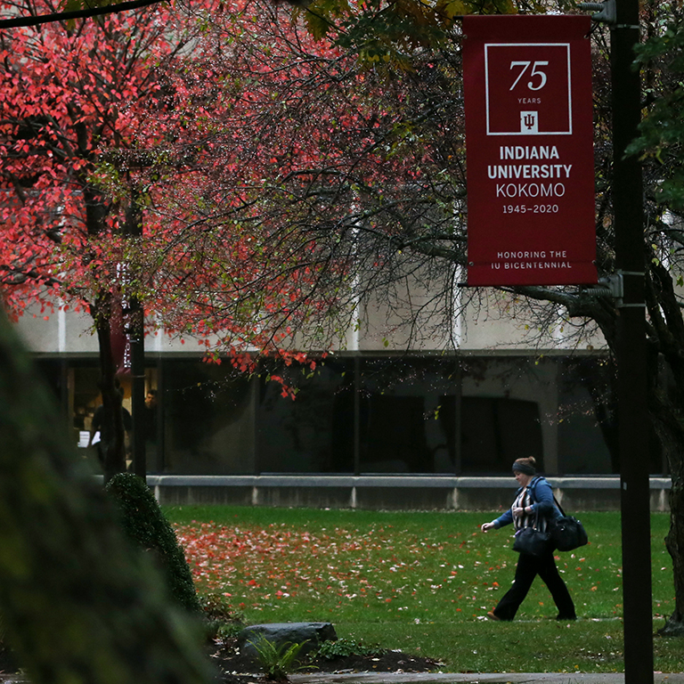 A red IU bicentennial banner in the quad