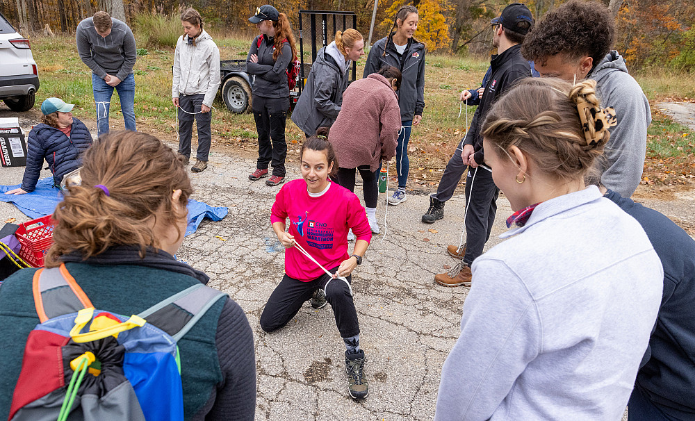 Amanda Thayer demonstrates a knot used to begin stabilizing a leg injury with existing materials during wilderness medicine training in I...