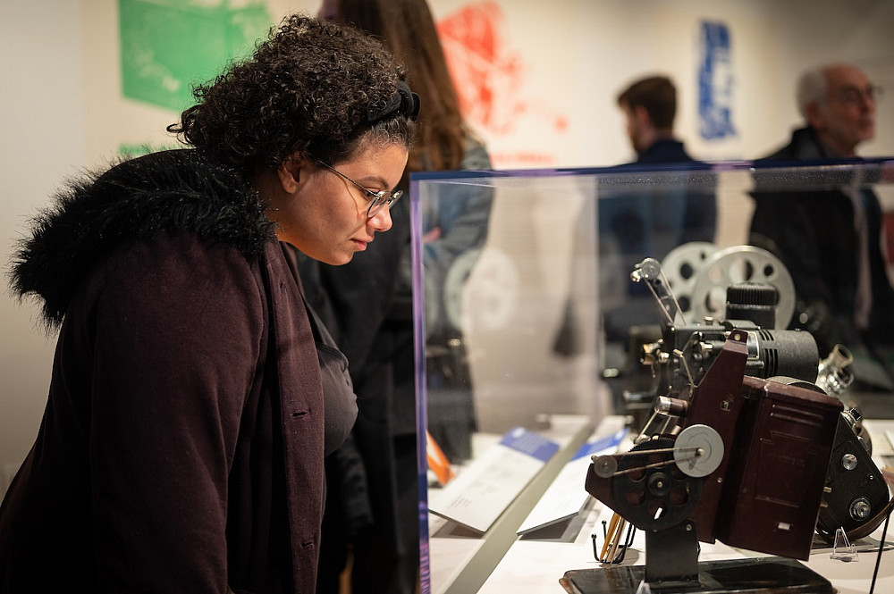 Ursula Romero, outreach librarian at the Indiana University Lilly Library, observes displays at the 16mm Exhibition Reception in the McCa...