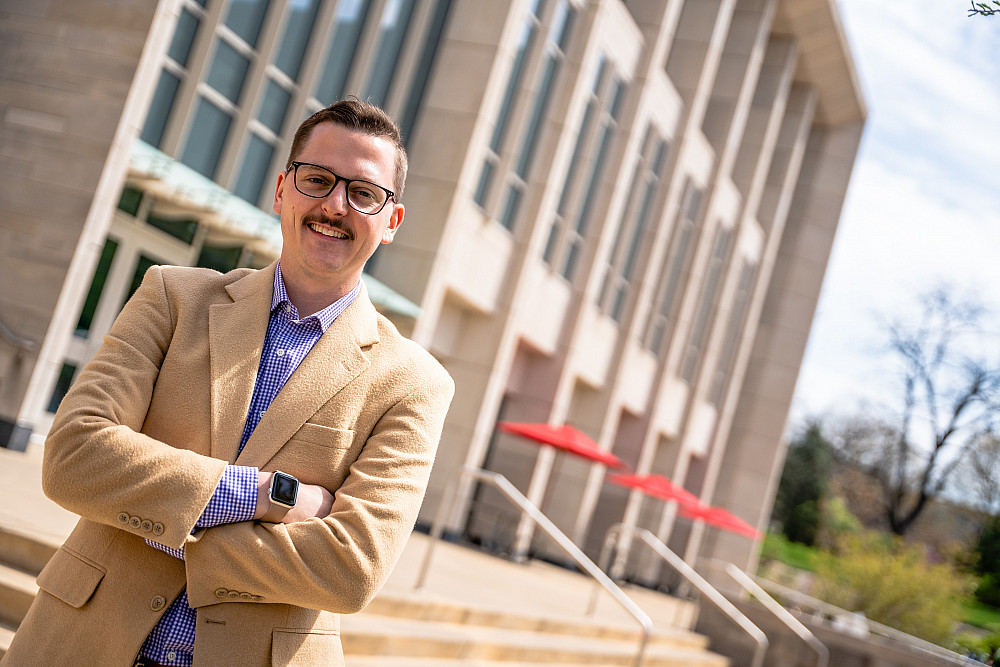 IU Alum Cody Smith standing in front of the Paul H. O'Neill School of Public and Environmental Affairs building in Bloomington, IN