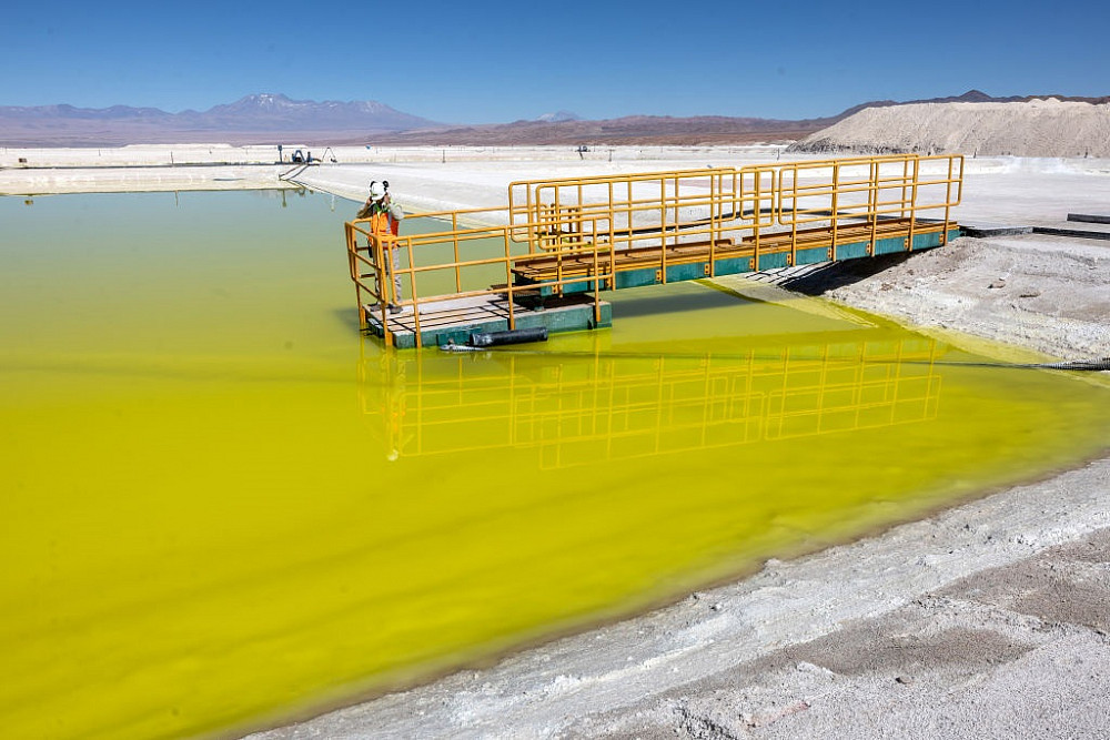 A lithium mine supervisor inspects an evaporation pond of lithium-rich brine in the Atacama Desert in Salar de Atacama, Chile. The Lithiu...