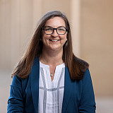 Beth Young, with the Office of the Chancellor, poses for a photograph in the breezeway outside the Business SPEA entrance. The photo was ...