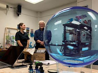 Herron student Brenna McCarty and Herron School Dean Greg Hull stand in the background as one of the first spheres for the 'Blue Skies' a...