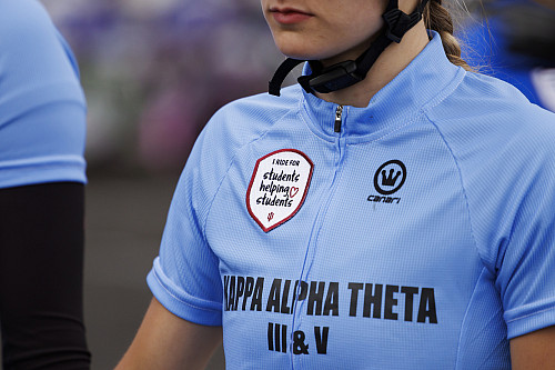 A Kappa Alpha Theta rider wears a patch for the Students Helping Students crowdfunding campaign at the Women's Little 500 at Bill Armstro...