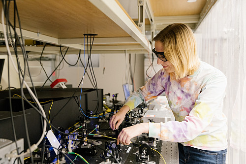 Marissa D'Onofrio works on a optics table