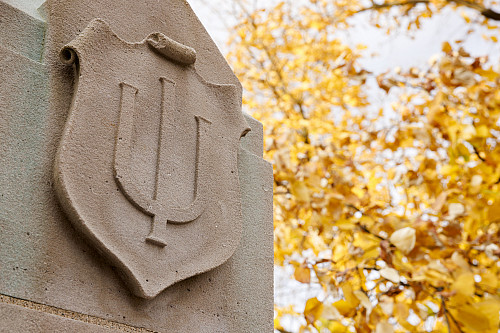 A limestone trident at IU Bloomington on a fall day