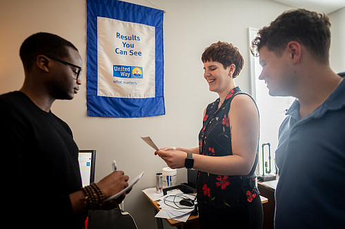 Jamil Davis (left) and Carter Inskeep (right) meet with their supervisor Catherine Blakensopp (center) to support fundraising efforts and...