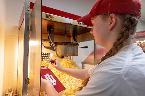Kate Thies preps boxes of concession stand popcorn during a men's basketball game at IU Bloomington on Tuesday, Feb. 28, 2023. (Photo by ...