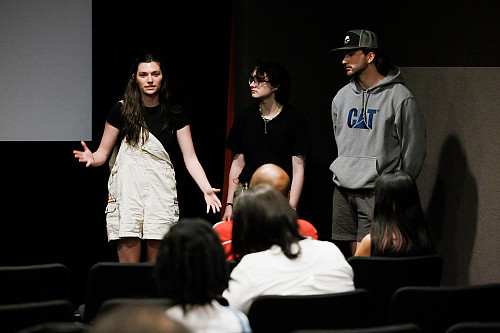 Indiana University student Louise Kern-Kensler, left, introduces her team's film, The Brass Ceiling, during a screening of the Advan...