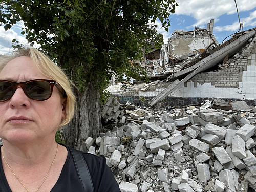 Elizabeth Dunn in front of debris in Ukraine