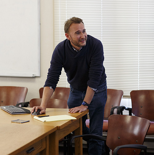 Scott Shackelford stands at a table