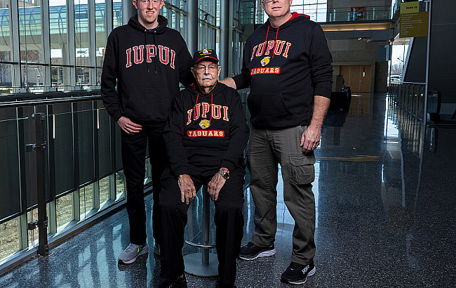 Jared Hutchek (left), a senior at IUPUI, poses for a portrait with his grandfather, Andy (center), and his father, Jim, at the Campus Center