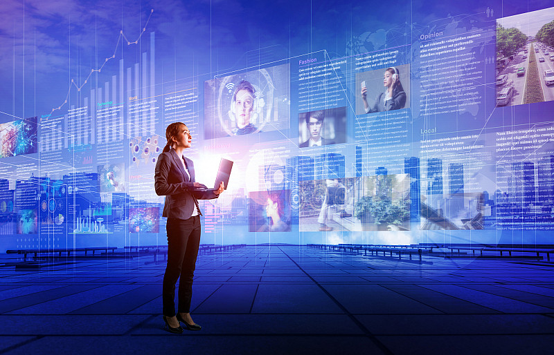 Woman standing with a laptop, against a backdrop of web images.