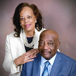 A man and woman smile for a photo.