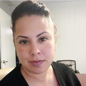 A woman takes a selfie indoors.