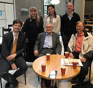 A group of people smiling at the screen.