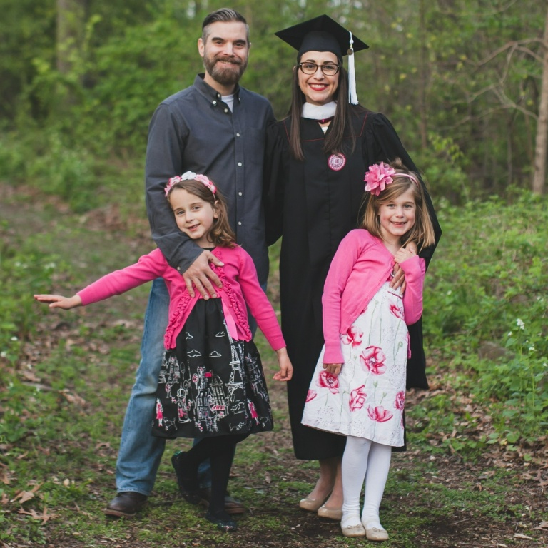 Natalie Vega-Finn, Director of Academic Advising at Indiana University Northwest, in her cap and gown alongside her family. 