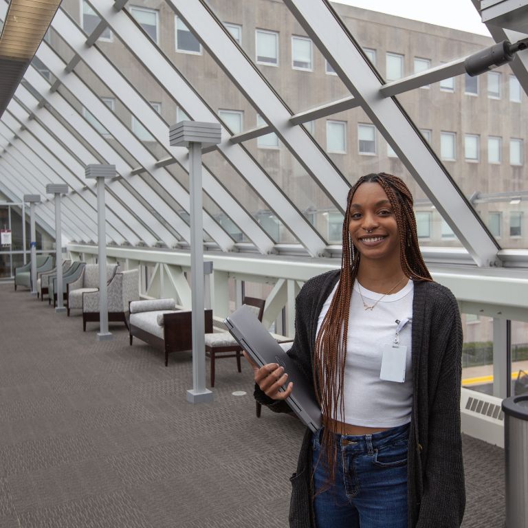 Indiana University Northwest student Alaiya Melton stands in a walkway outside of Community Hospital in Munster, Indiana.