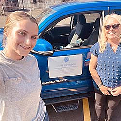Two women stand by decal that reads Josephine's Clinic