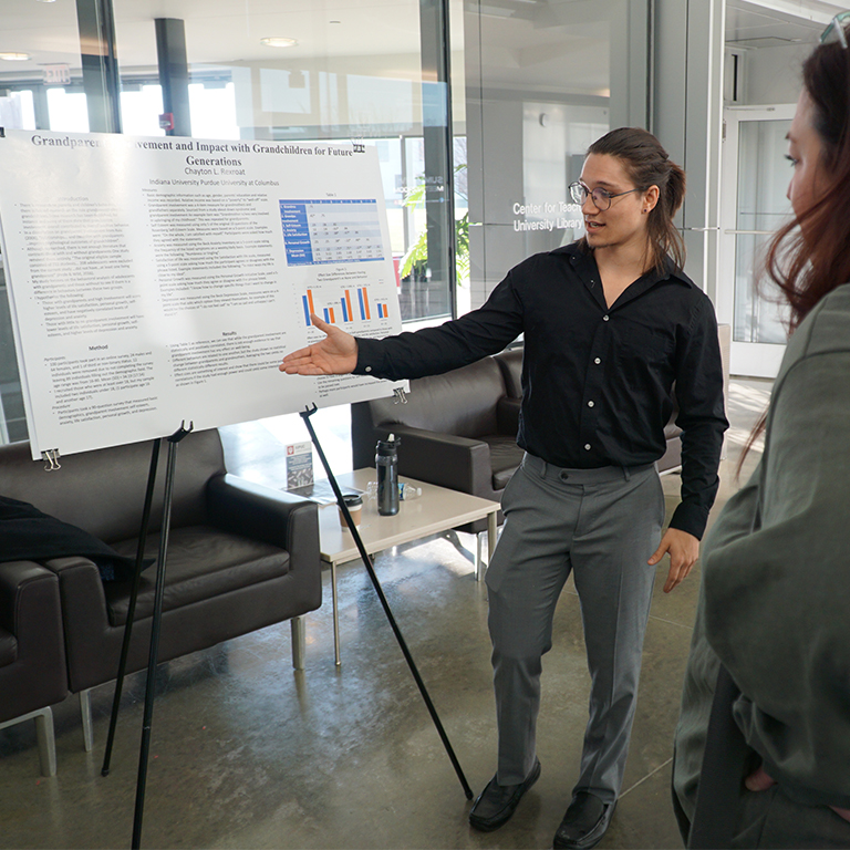 Student presenting research at Psychology Capstone Event