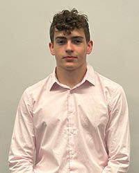 Brody Puckett smiles in front of a neutral background