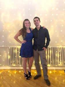 Couple stands together, surrounded by sparkling lights