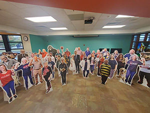 Room filled with cardboard standees of people from IU East