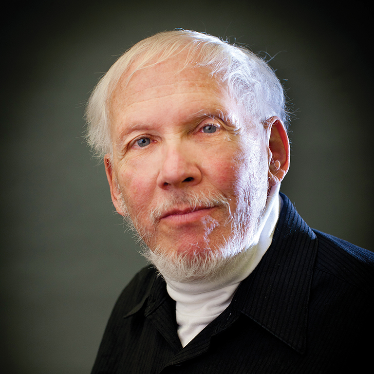 Close-up of Paul Kriese, Ph.D., IU East Professor Emeritus of Political Science in front of a vignette background