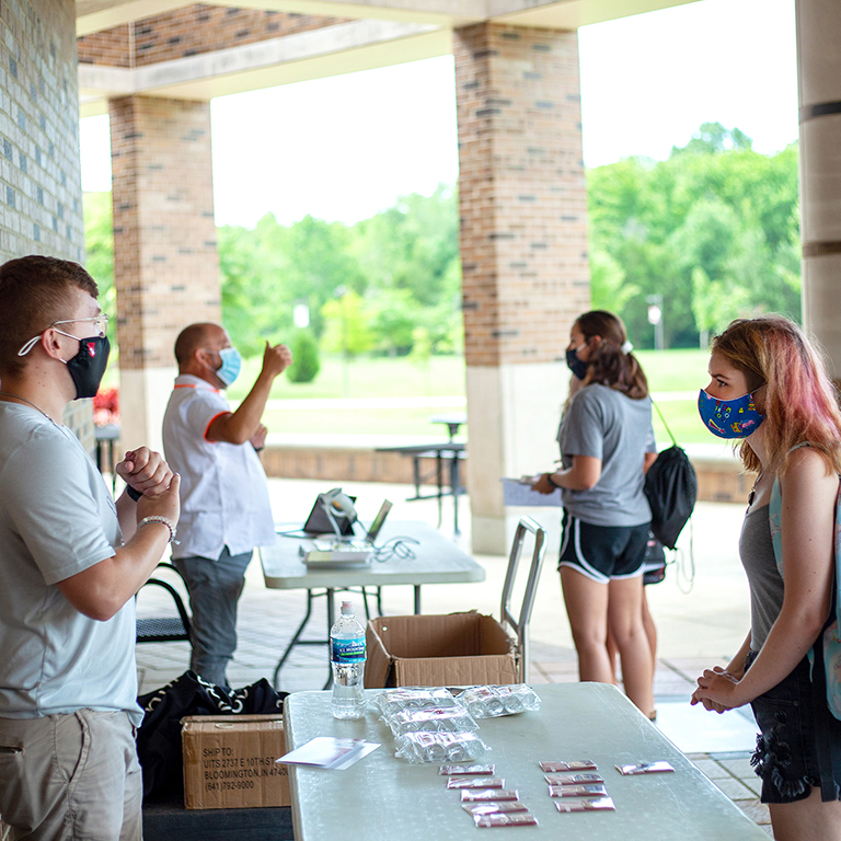 incoming freshmen meet with current students and staff during First Year Open House in 2020. Everyone is wearing protective masks.